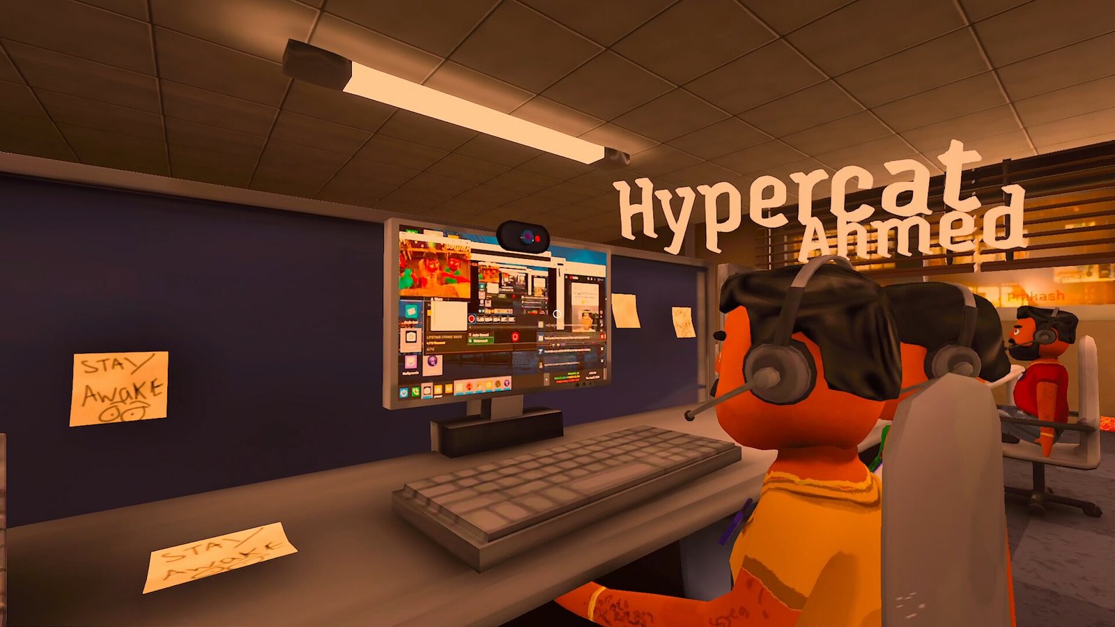Two workers share a workstation under a Stay Awake note. Official screenshot.